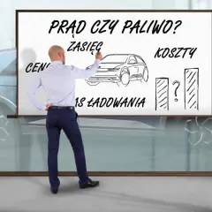 Mężczyzna pisze na tablicy "Prąd czy paliwo?", porównując zasięg, koszty i czas ładowania samochodu elektrycznego.