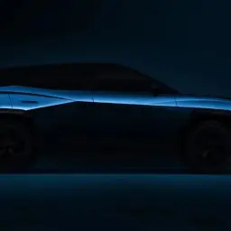 Nowy Omoda 3 w ciemności, z niebieskim podświetleniem podkreślającym jego futurystyczny design.