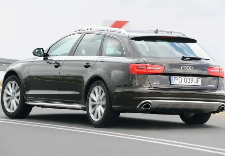 Ciemnobrązowe Audi A6 C6 Avant Allroad jadące po drodze.