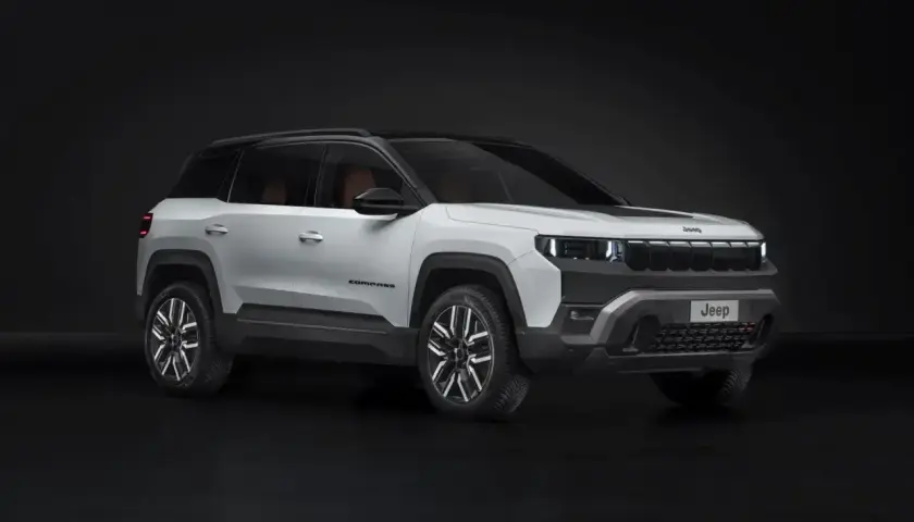 Biały Jeep Compass na ciemnym tle. Zwróć uwagę na jego nowoczesny design i wymiary, idealne do miasta i w teren.